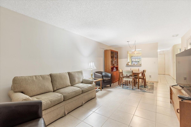 living room featuring light tile patterned floors and a textured ceiling