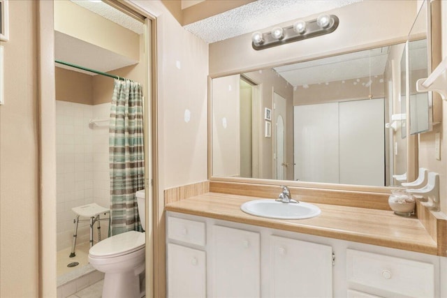 bathroom featuring vanity, tile patterned floors, a shower with shower curtain, toilet, and a textured ceiling