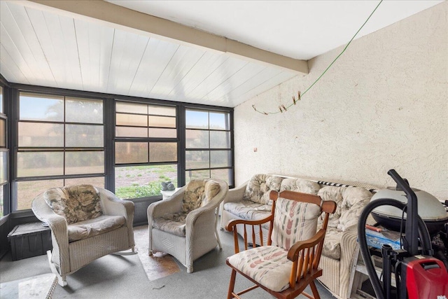 living area featuring beamed ceiling