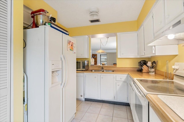 kitchen featuring sink, light tile patterned floors, pendant lighting, white appliances, and white cabinets