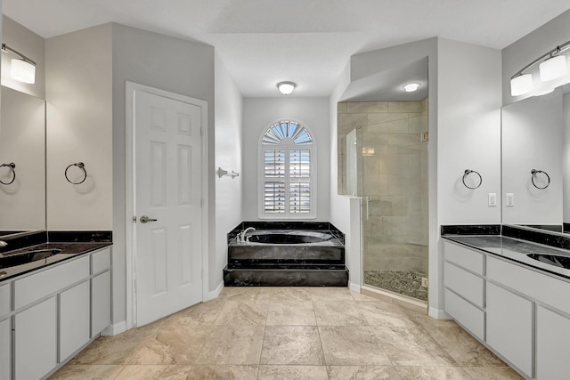 bathroom featuring vanity and independent shower and bath