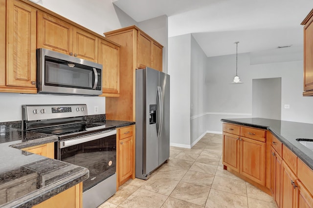 kitchen featuring appliances with stainless steel finishes, decorative light fixtures, and light tile patterned floors