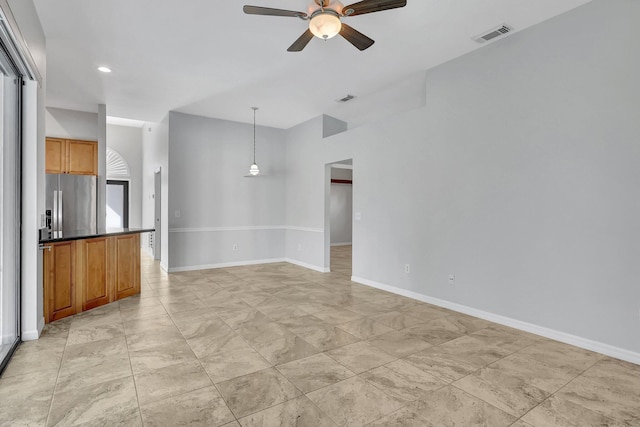 unfurnished living room with ceiling fan