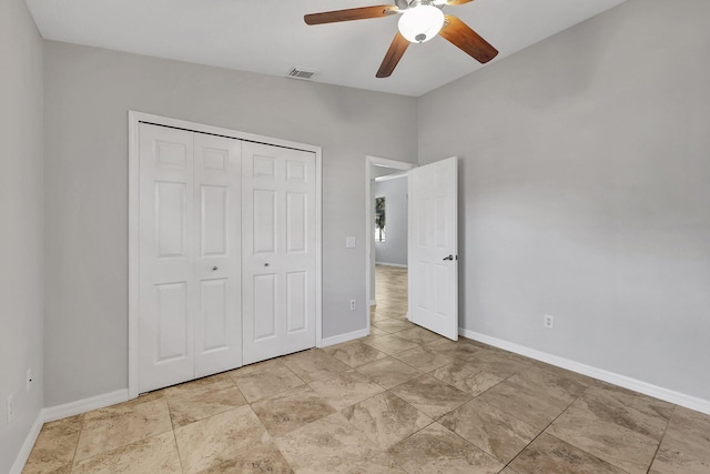 unfurnished bedroom with ceiling fan and a closet