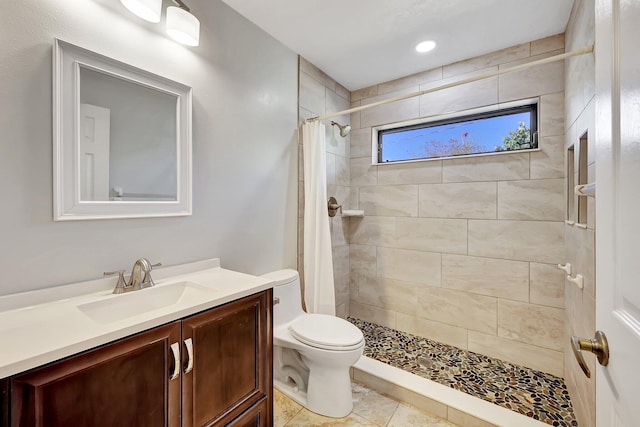 bathroom with tile patterned flooring, vanity, curtained shower, and toilet