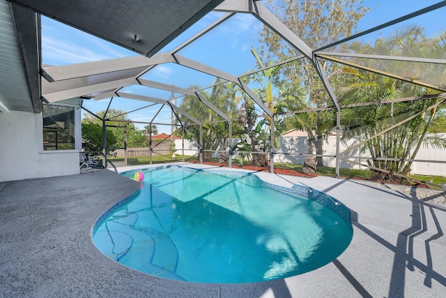 view of swimming pool featuring a lanai and a patio