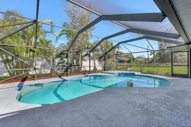 view of pool featuring glass enclosure and a patio