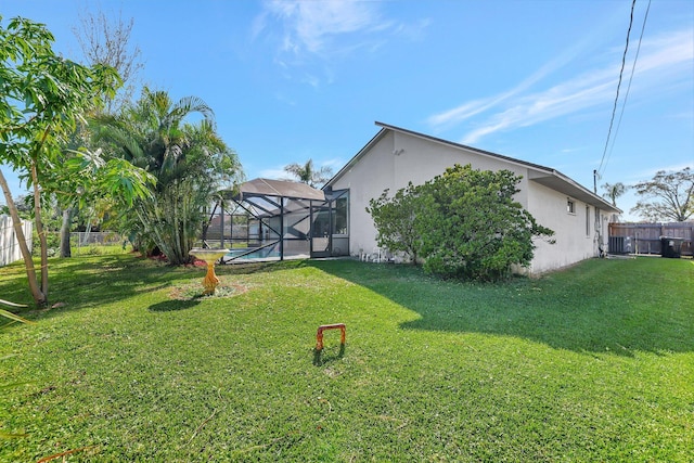 view of yard featuring a fenced in pool and a lanai