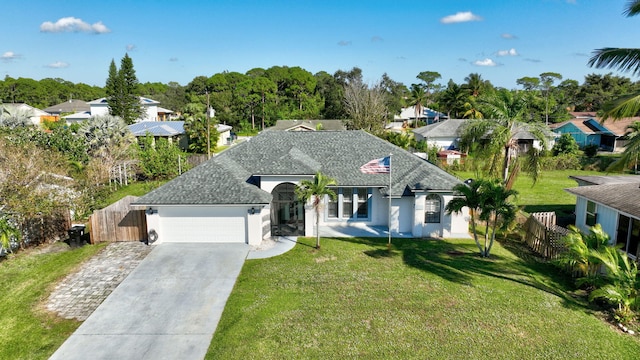 view of front of house featuring a garage and a front yard