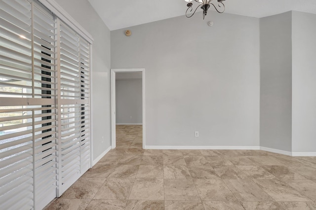 unfurnished bedroom with a notable chandelier and lofted ceiling