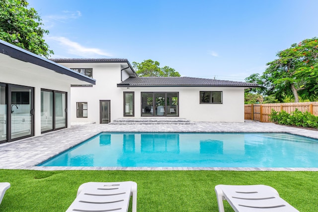 view of swimming pool featuring a lawn and a patio