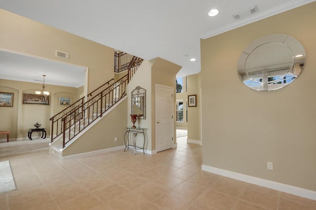 interior space featuring stairs, light tile patterned floors, visible vents, and baseboards