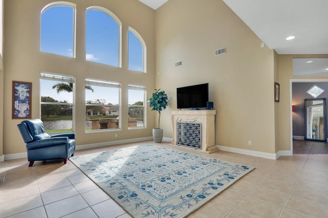 tiled living area with recessed lighting, visible vents, a fireplace, and baseboards