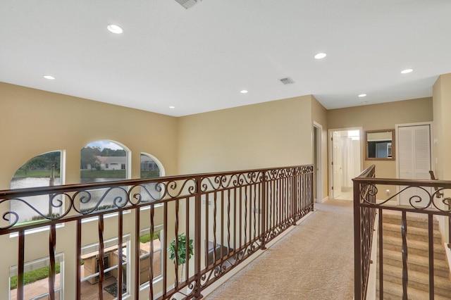 hallway featuring recessed lighting, a healthy amount of sunlight, carpet flooring, and visible vents