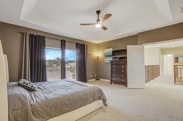 bedroom featuring carpet flooring, a ceiling fan, visible vents, baseboards, and a raised ceiling