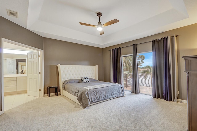 bedroom featuring carpet floors, access to exterior, a raised ceiling, and visible vents