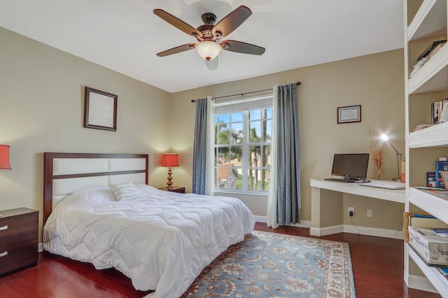 bedroom featuring ceiling fan, baseboards, and wood finished floors