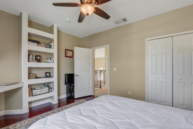 bedroom featuring a closet, visible vents, ceiling fan, wood finished floors, and baseboards