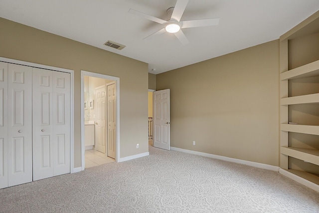 unfurnished bedroom featuring a closet, visible vents, carpet flooring, connected bathroom, and baseboards