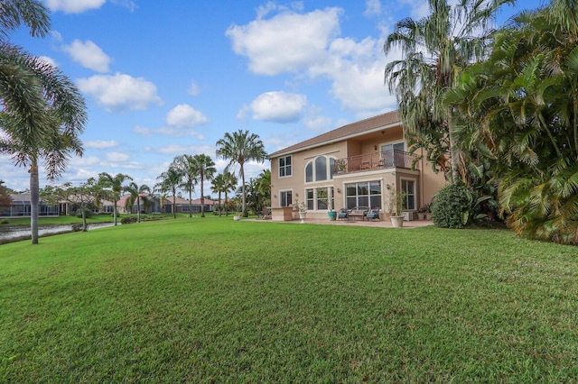 view of yard with a patio and a balcony