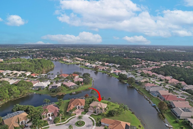 drone / aerial view featuring a water view and a residential view