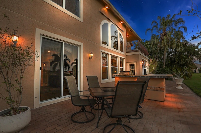 view of patio / terrace featuring outdoor dining space and a balcony