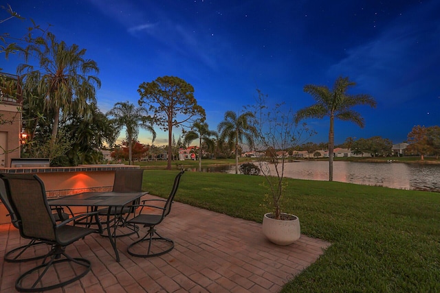 view of patio / terrace with a water view and outdoor dining space