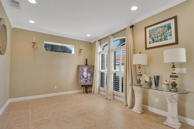 living area featuring visible vents, baseboards, and crown molding