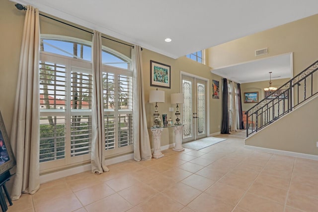 tiled entrance foyer featuring recessed lighting, visible vents, an inviting chandelier, baseboards, and stairs