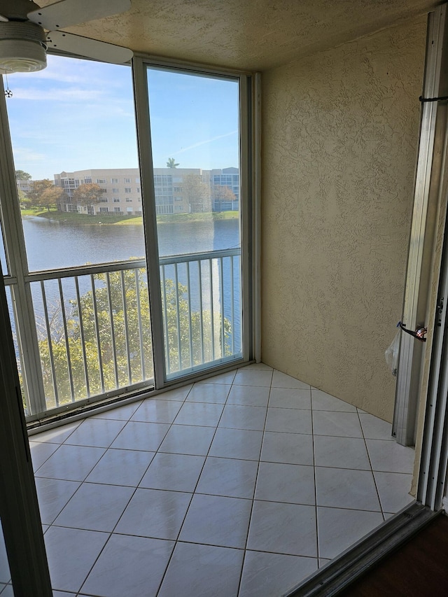 unfurnished sunroom featuring a healthy amount of sunlight and a water view