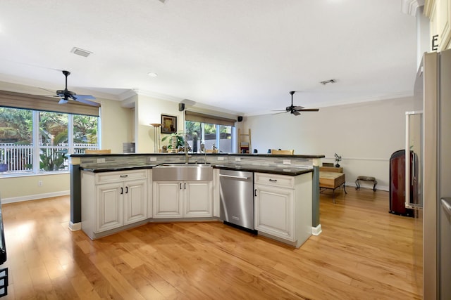 kitchen with white cabinets, light hardwood / wood-style floors, sink, and appliances with stainless steel finishes