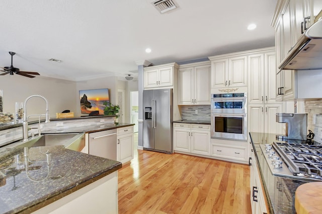 kitchen with white cabinetry, sink, ceiling fan, tasteful backsplash, and appliances with stainless steel finishes