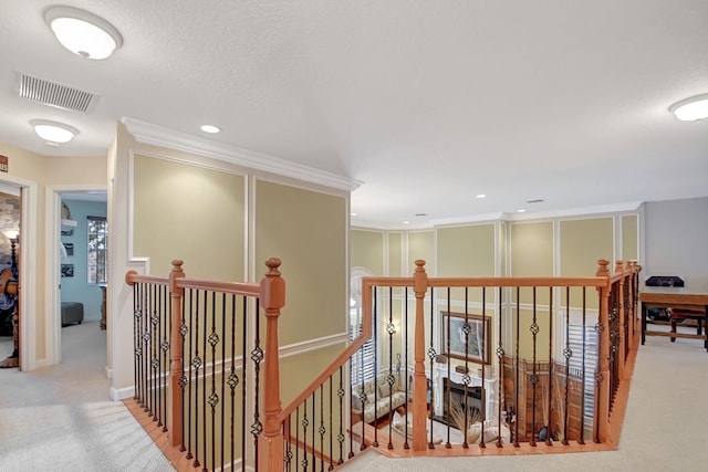 hall with light colored carpet and crown molding