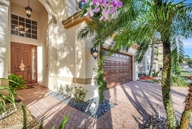 doorway to property with a garage