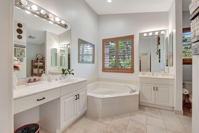 bathroom featuring a bathing tub, tile patterned flooring, toilet, and vanity