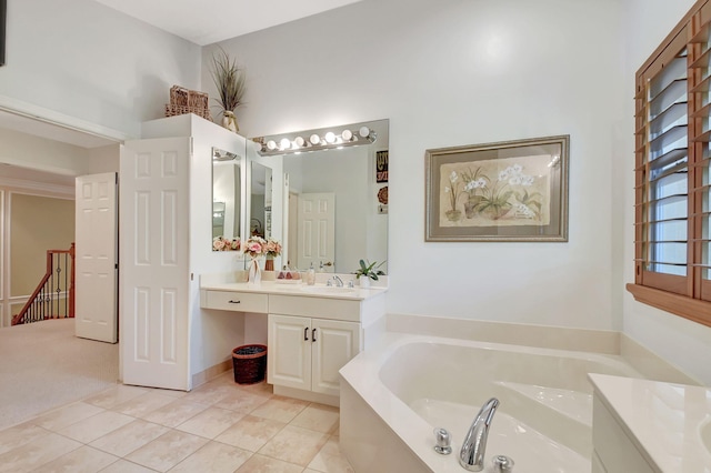 bathroom with vanity, tile patterned floors, and a bathing tub