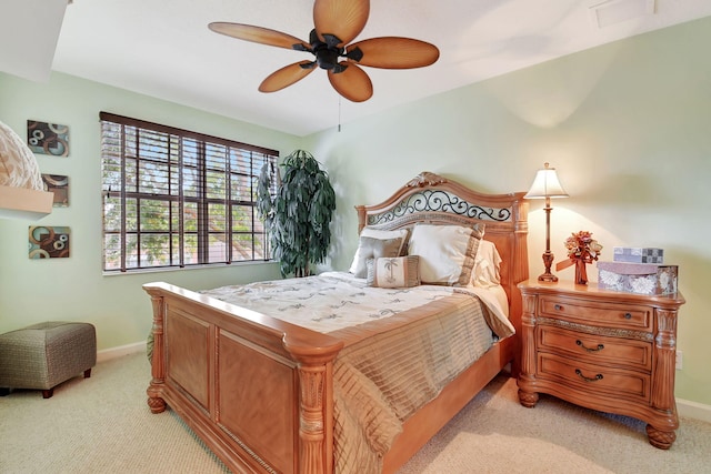 bedroom featuring light colored carpet and ceiling fan