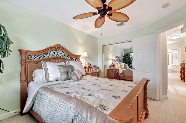 carpeted bedroom with a closet and ceiling fan