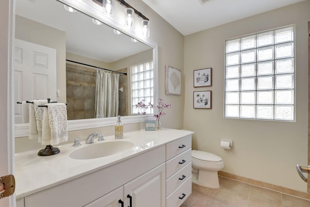 bathroom with tile patterned floors, a shower with curtain, vanity, and toilet