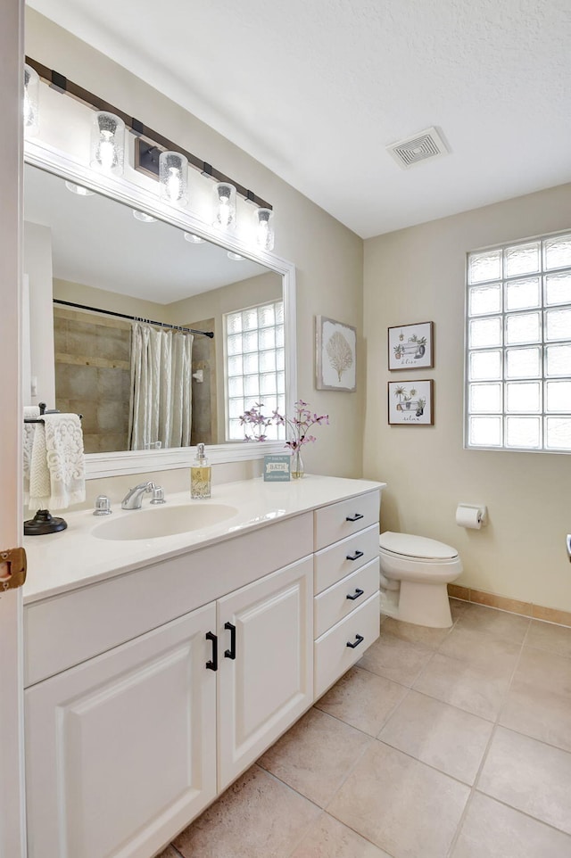 bathroom with tile patterned flooring, a textured ceiling, toilet, vanity, and a shower with shower curtain