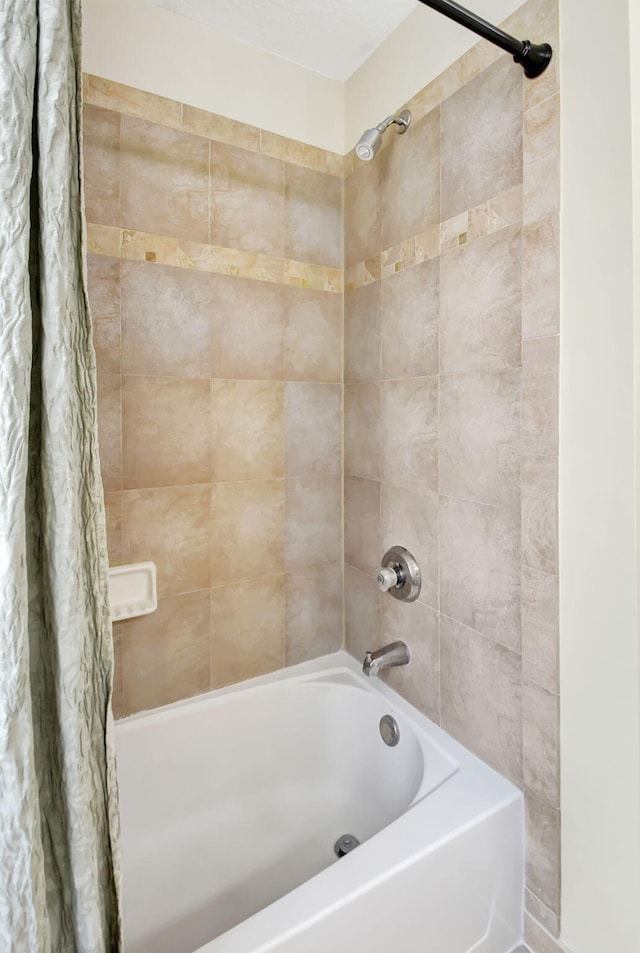 bathroom with shower / bath combination with curtain