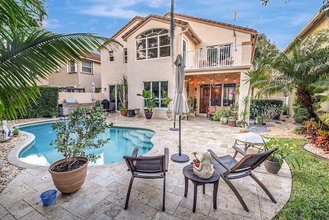 view of swimming pool featuring a patio area and area for grilling