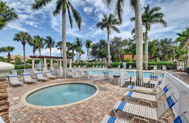 view of pool with a patio, a pergola, and a hot tub