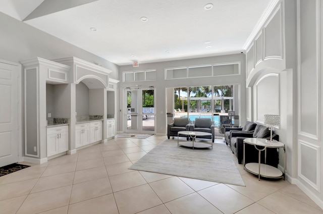 living room featuring french doors and light tile patterned floors