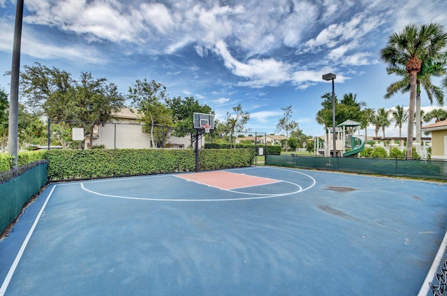 view of basketball court featuring a playground