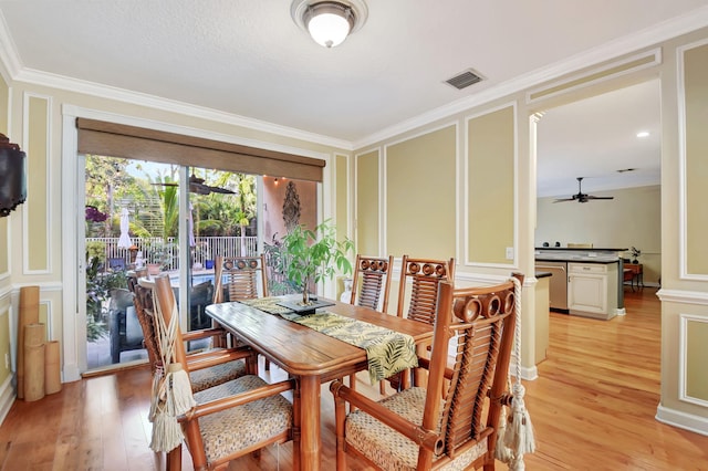 dining space featuring light wood-type flooring, ceiling fan, and crown molding