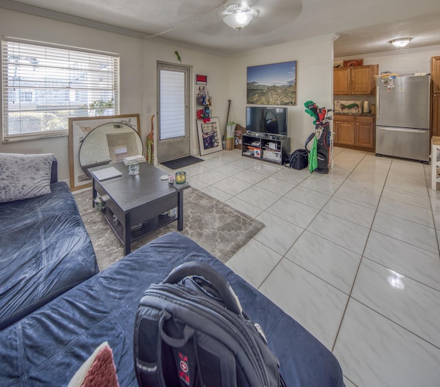 living room featuring ceiling fan, crown molding, and light tile patterned flooring