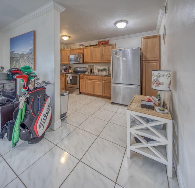 kitchen featuring stainless steel appliances, a textured ceiling, and ornamental molding