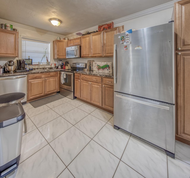 kitchen featuring a textured ceiling, sink, crown molding, and appliances with stainless steel finishes