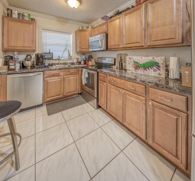 kitchen with appliances with stainless steel finishes, dark stone counters, ornamental molding, and sink